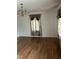 A living room featuring a chandelier, hardwood floors, and floral curtains at 836 S Main St, Roxboro, NC 27573