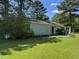 The backyard boasts a beautiful lawn, patio, and a sliding door entrance to the home at 8405 Falcon Crest Cir, Angier, NC 27501