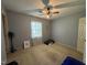 Comfortable bedroom featuring a ceiling fan, natural light, and carpeted floor at 8405 Falcon Crest Cir, Angier, NC 27501