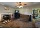 Spacious living room featuring a decorative fireplace, ceiling fan, and neutral walls at 8405 Falcon Crest Cir, Angier, NC 27501