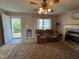 Cozy living room featuring a decorative rug, fireplace, and a comfortable reclining sofa at 8405 Falcon Crest Cir, Angier, NC 27501