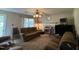 Comfortable living room with a fireplace, ceiling fan, and neutral color palette at 8405 Falcon Crest Cir, Angier, NC 27501