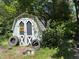 A small shed surrounded by tires, under some trees, suitable for storage and outdoor projects at 8405 Falcon Crest Cir, Angier, NC 27501