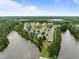 Expansive aerial view of a quiet neighborhood, nestled between lush green trees and a tranquil lake at 100 Stratford Lakes Dr # 270, Durham, NC 27713