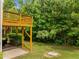 Backyard view features a deck overlooking a spacious lawn and mature trees, creating a private outdoor oasis at 100 Stratford Lakes Dr # 270, Durham, NC 27713