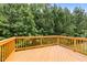 Exterior shot of a private wooden balcony surrounded by lush green trees at 100 Stratford Lakes Dr # 270, Durham, NC 27713