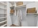 Walk-in closet featuring built-in shelving and storage baskets at 100 Stratford Lakes Dr # 270, Durham, NC 27713