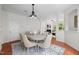 Bright dining area with hardwood floors, chandelier, and easy flow to the fireplace in the living room at 100 Stratford Lakes Dr # 270, Durham, NC 27713