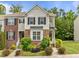 Charming townhouse featuring a mix of brick and siding, complemented by lush landscaping and beautiful shrubbery at 100 Stratford Lakes Dr # 270, Durham, NC 27713