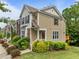 Well-maintained townhouse with brick and siding exterior, complemented by beautiful landscaping and shrubbery at 100 Stratford Lakes Dr # 270, Durham, NC 27713