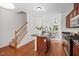 Open-concept kitchen with an island and views of the dining area and staircase at 100 Stratford Lakes Dr # 270, Durham, NC 27713