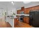 Bright kitchen featuring dark wood cabinetry, granite countertops, and stainless steel appliances at 100 Stratford Lakes Dr # 270, Durham, NC 27713