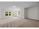 Bright living room featuring neutral carpet, recessed lights and large windows at 100 Stratford Lakes Dr # 270, Durham, NC 27713