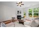 Cozy living room with a fireplace, ceiling fan, plush seating, and views of a private balcony at 100 Stratford Lakes Dr # 270, Durham, NC 27713