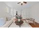 Bright living room featuring neutral decor, plush sofa, hardwood floors and natural light, open to dining area at 100 Stratford Lakes Dr # 270, Durham, NC 27713