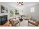 Bright living room featuring a fireplace, comfortable seating, and a door to a private balcony at 100 Stratford Lakes Dr # 270, Durham, NC 27713