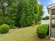 A lush backyard with mature trees and manicured shrubs offering privacy at 1020 Kingston Grove Dr, Cary, NC 27519
