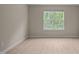 Bright bedroom featuring wood-look flooring and a window with a pleasant view at 1020 Kingston Grove Dr, Cary, NC 27519