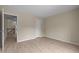 A bright bedroom features neutral walls, laminate floors, and white door at 1020 Kingston Grove Dr, Cary, NC 27519