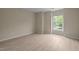 Cozy bedroom featuring a large window and wood-look floors at 1020 Kingston Grove Dr, Cary, NC 27519