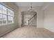 Bright dining space with wood-look floors, a modern light fixture, and views of the staircase at 1020 Kingston Grove Dr, Cary, NC 27519