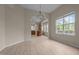 Inviting dining area with wood floors, large windows, and a modern chandelier at 1020 Kingston Grove Dr, Cary, NC 27519