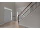 A bright foyer with wood-look flooring, a staircase, and a front door with glass panels at 1020 Kingston Grove Dr, Cary, NC 27519