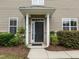 Charming front entrance with a black door, white columns, and manicured landscaping at 1020 Kingston Grove Dr, Cary, NC 27519