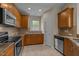 Charming kitchen featuring stainless steel appliances and wood cabinets at 1020 Kingston Grove Dr, Cary, NC 27519
