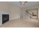 Spacious living room features a fireplace, wood-look floors, and staircase access at 1020 Kingston Grove Dr, Cary, NC 27519