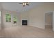 Bright living room with a fireplace, wood-look floors and access to the back deck at 1020 Kingston Grove Dr, Cary, NC 27519