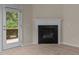 Close up of the living room fireplace and access to the back deck at 1020 Kingston Grove Dr, Cary, NC 27519