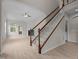 Open-concept living room features high ceilings, a ceiling fan, fireplace, and access to a deck at 1020 Kingston Grove Dr, Cary, NC 27519