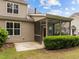 Backyard view of a cozy screened porch and well-maintained landscaping at 1020 Kingston Grove Dr, Cary, NC 27519