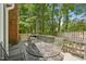 This outdoor back deck includes mature trees, an outdoor grill, and outdoor seating at 103 Lakeway Ct, Cary, NC 27511