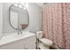 The bathroom features a sink, oval mirror, toilet, floral shower curtain, and grey walls at 103 Lakeway Ct, Cary, NC 27511