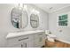 Renovated bathroom featuring double sink vanity, modern lighting, and updated fixtures at 103 Lakeway Ct, Cary, NC 27511