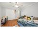 This bedroom includes hardwood floors, a ceiling fan, and a closet with bi-fold doors at 103 Lakeway Ct, Cary, NC 27511