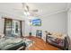 This bedroom includes wood floors, a ceiling fan, and a large window with nice outside views at 103 Lakeway Ct, Cary, NC 27511