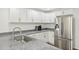 Spacious kitchen offers granite counters, stainless steel appliances, and white cabinets at 103 Lakeway Ct, Cary, NC 27511