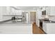 Well lit kitchen features granite countertops, stainless steel appliances, and white cabinets at 103 Lakeway Ct, Cary, NC 27511