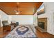 A cozy living room featuring a fireplace, hardwood floors, and a TV at 103 Lakeway Ct, Cary, NC 27511