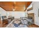 Bright living room with wooden ceiling, stone fireplace, and a ceiling fan at 103 Lakeway Ct, Cary, NC 27511