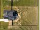 Aerial view of a gray home with a large backyard, outdoor kitchen, and fire pit at 105 Scotland Dr, Youngsville, NC 27596