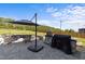 Backyard patio featuring a grill, stone countertop, fire pit, and a lovely wooded view at 105 Scotland Dr, Youngsville, NC 27596