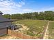 Expansive backyard with a privacy fence, outdoor firepit, and screened-in porch at 105 Scotland Dr, Youngsville, NC 27596
