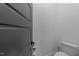 Close-up view of a sleek modern door with black hardware and a toilet in a minimalist bathroom at 105 Scotland Dr, Youngsville, NC 27596