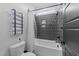 Clean, well-lit bathroom featuring a white bathtub with gray tiling and black fixtures at 105 Scotland Dr, Youngsville, NC 27596
