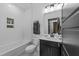Well-lit bathroom with a tub-shower combo featuring stylish tilework, modern fixtures, and a toilet at 105 Scotland Dr, Youngsville, NC 27596