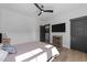 Cozy bedroom featuring a ceiling fan, mounted TV, and light-filled ambiance from bright, natural light at 105 Scotland Dr, Youngsville, NC 27596